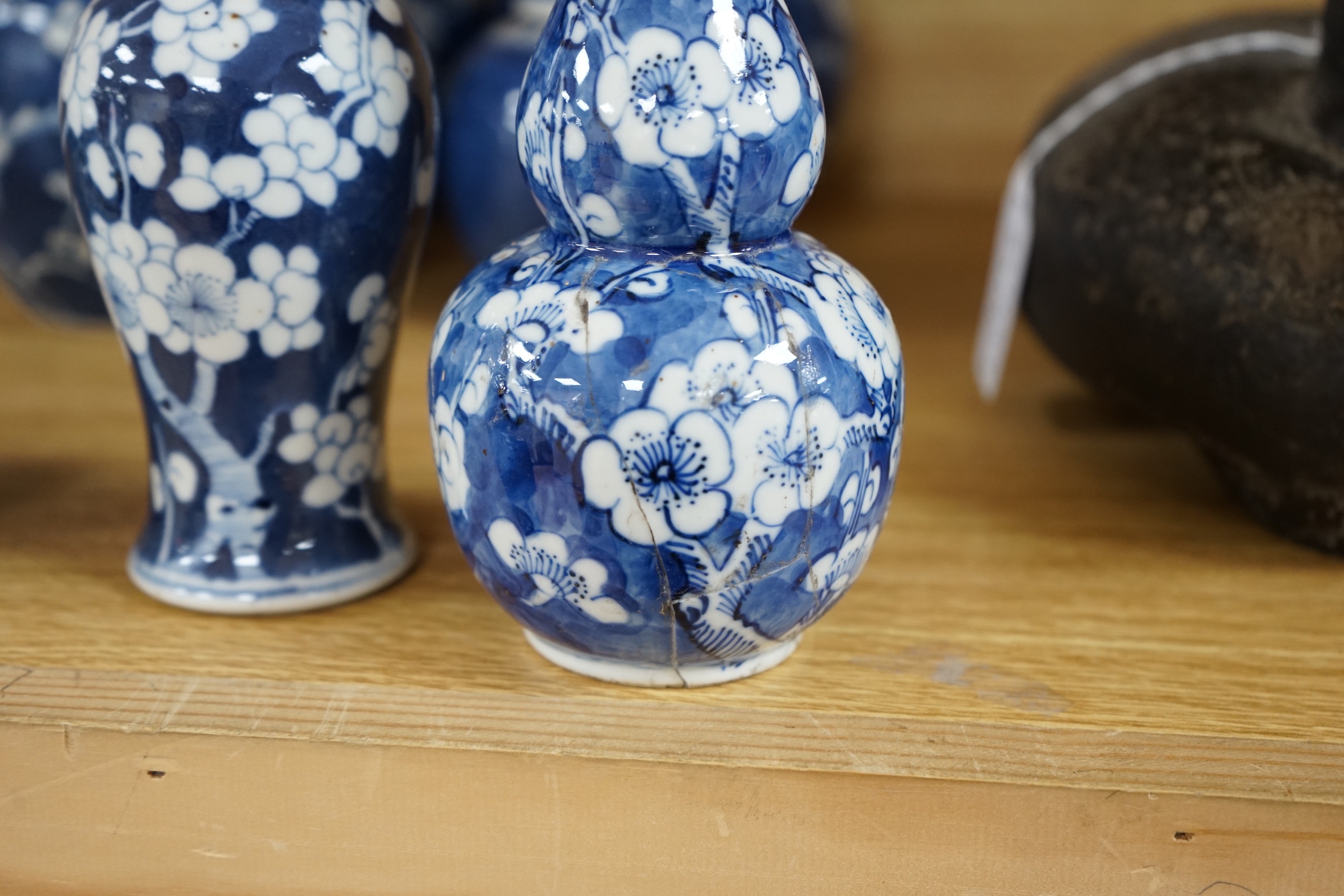 Four Chinese blue and white prunus pattern ginger jars, together with three similar vases. 19th/early 20th century, Tallest 15cm